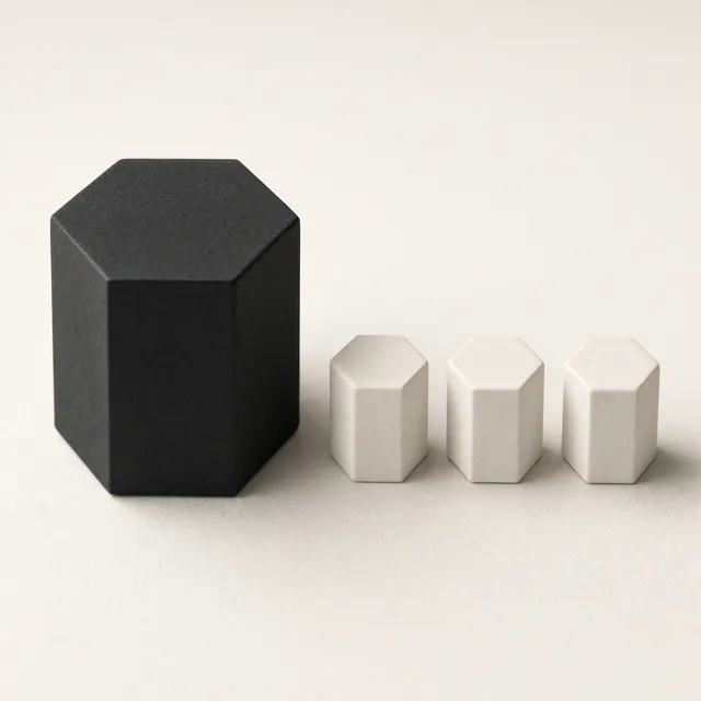 AI-made image: one large near-black hexagonal part with three small off-white parts lined up beside it, turned the same way